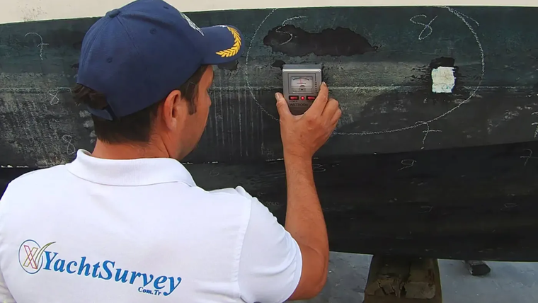 Moisture meter reading on a dark hull